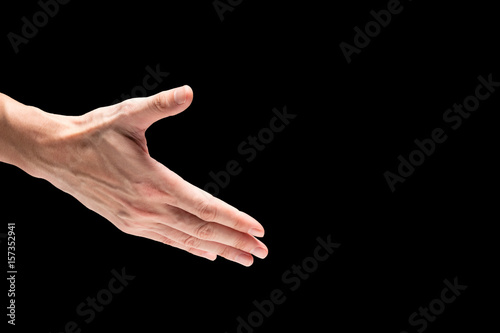 Male hand on a black background. Free space for text