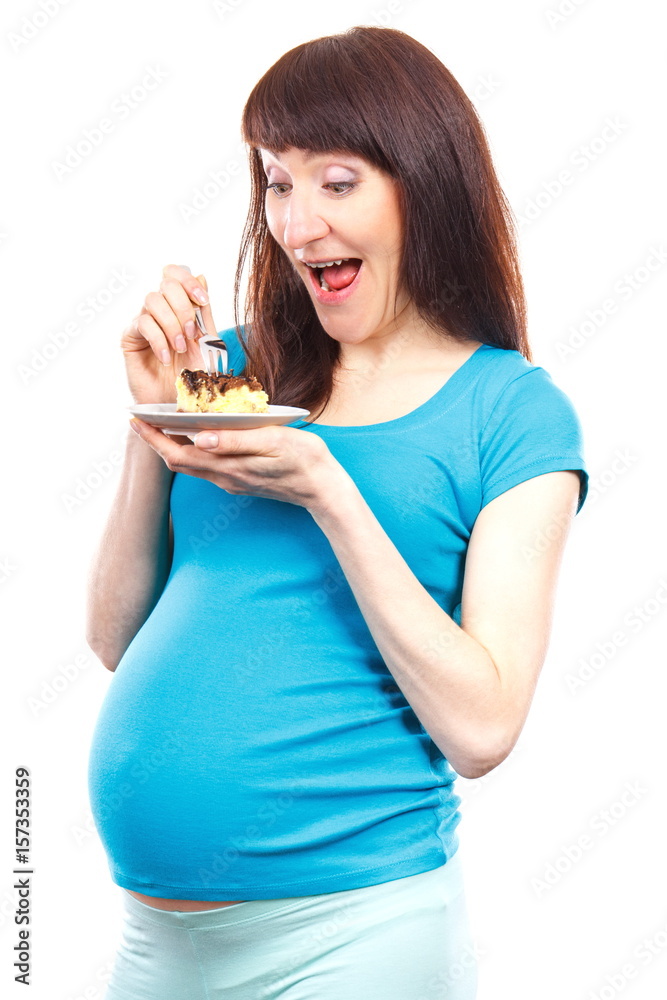 Happy delighted pregnant woman eating cheesecake, concept of nutrition during pregnancy Happy delighted pregnant woman eating cheesecake, concept of nutrition during pregnancy