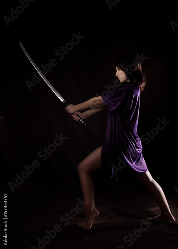 beautiful sexy woman with samurai sword. sexy woman with katana photo