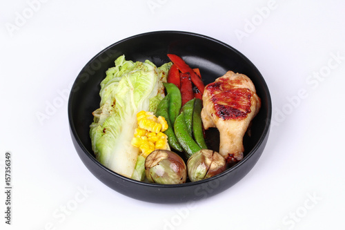 Chicken drumstick steak and grilled mixed vegetables .
