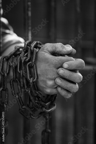 Prisoner's hands in chains © alexincaliphoto