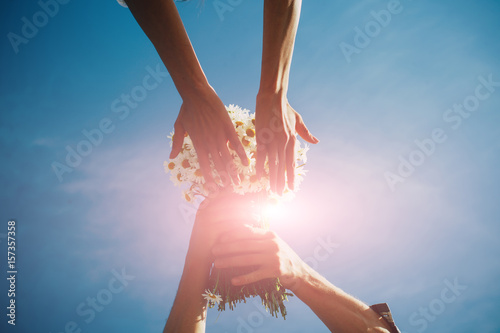 Hand. Flowers hands. Help me. Dreaming. Love stroy. Love concept. Fashion photo. Sky background. Lifestyle. Dream. photo