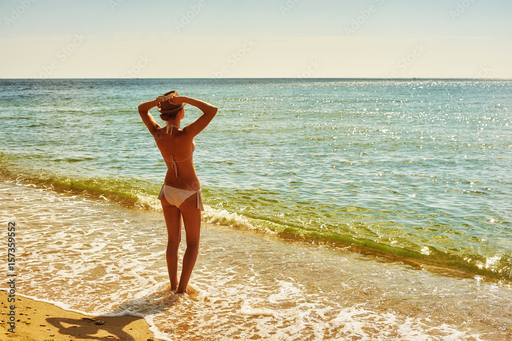 Young woman on the beach .The concept of summer vacation Young woman on the beach .The concept of summer vacation