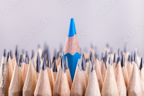 One sharpened blue pencil among many ones photo