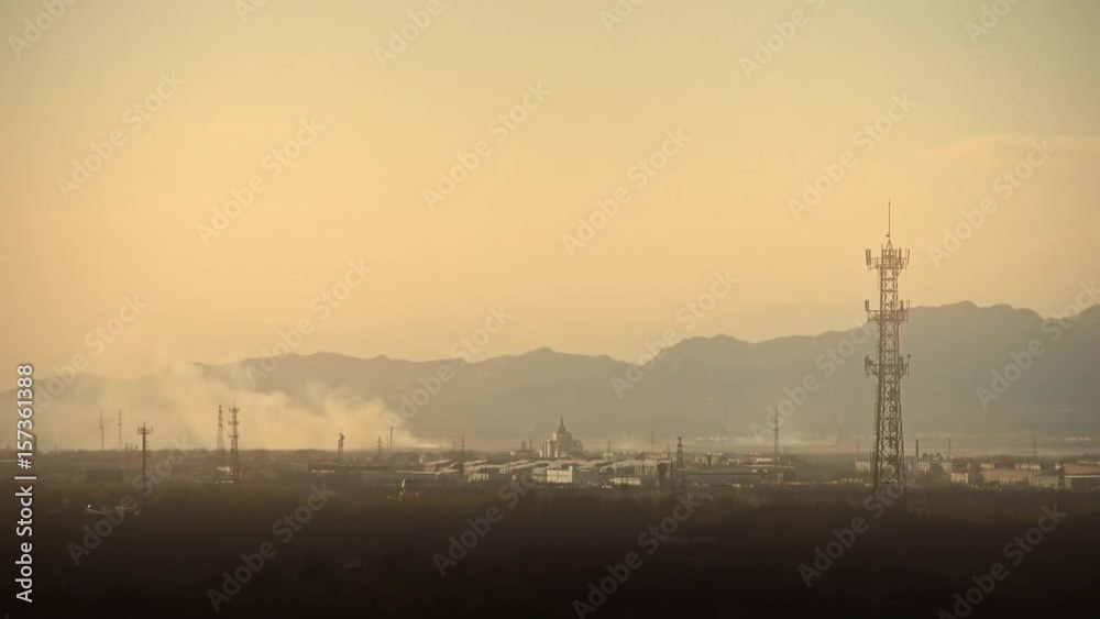 Panoramic of city town & factory smoke rely on mountain,Tower on hill at dusk. Panoramic of city town & factory smoke rely on mountain,Tower on hill at dusk.