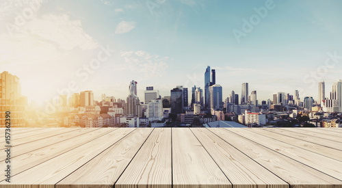 Panoramic Bangkok cityscape in sunrise with empty wooden floor