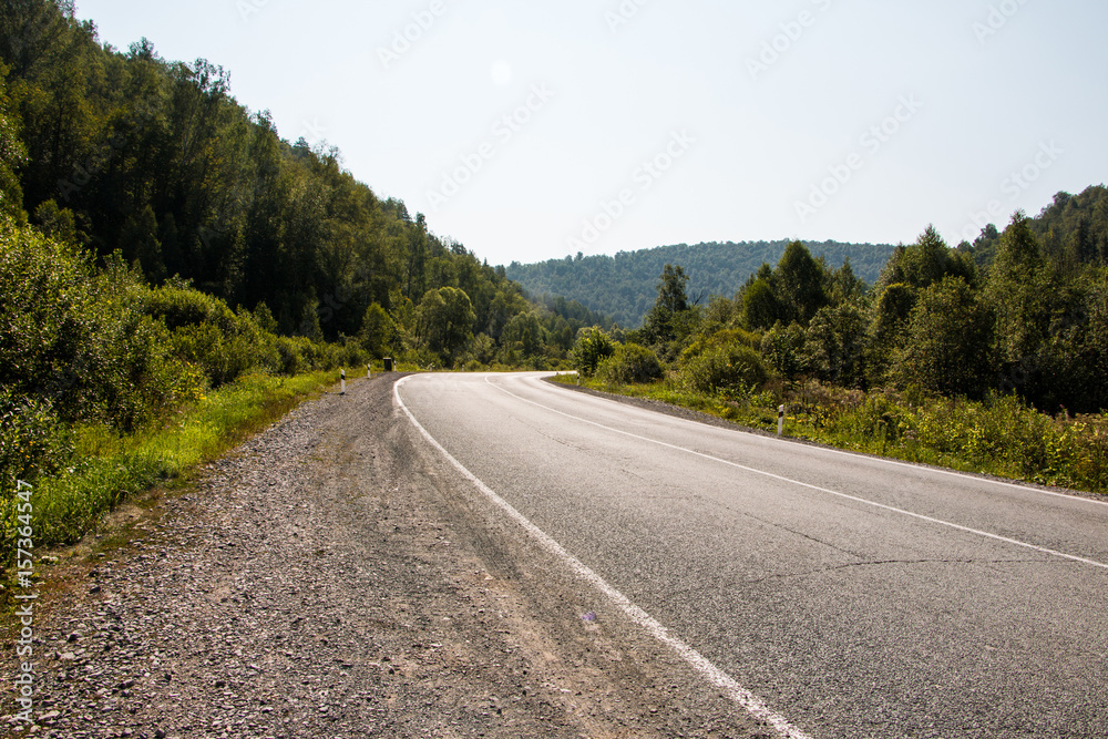 Fototapeta premium Road in mountain and trees around