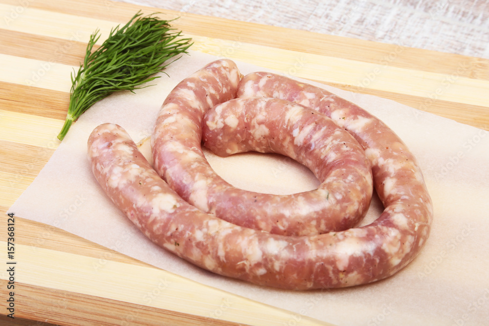 Homemade Raw sausage with spices on a wooden background. Homemade Raw sausage with spices on a wooden background.