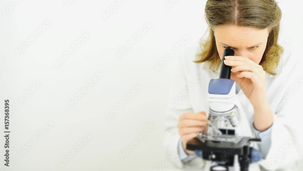 Scientist using microscope in laboratory. Space for text. Scientist using microscope in laboratory. Space for text.