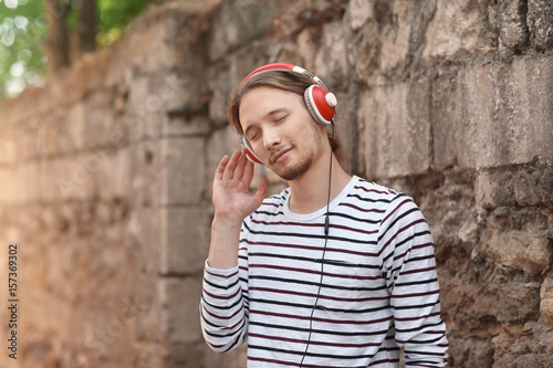 Handsome young man listenin...