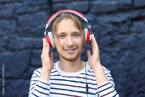 Handsome young man listenin...