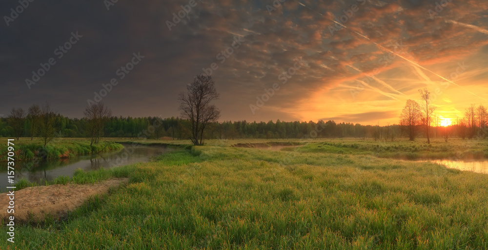 Fototapeta premium Vivid sunrise over meadow