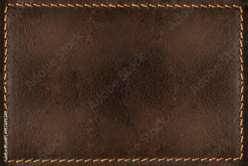 Brown leather background with seams photo