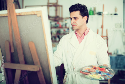 Male artist drawing in studio photo