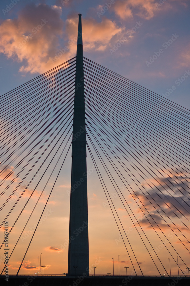 Silhouette of a huge cable bridge over Sava river at sunset in Belgrade, Serbia