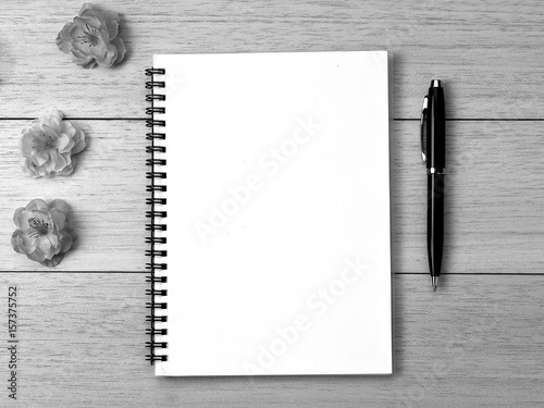 spiral notebook and pen on desk background