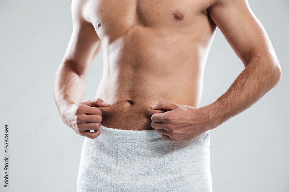 Cropped image of young man dressed in towel Cropped image of young man dressed in towel
