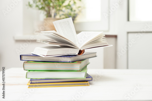 A stack of books on a white table