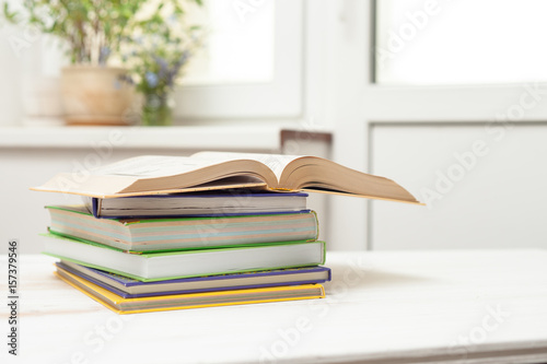 A stack of books on a white table