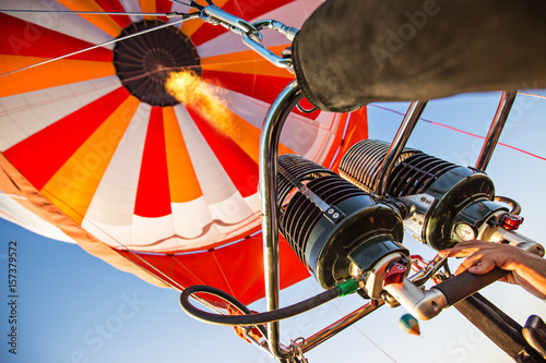 A hot air baloon rising high. Unusual perspective view.