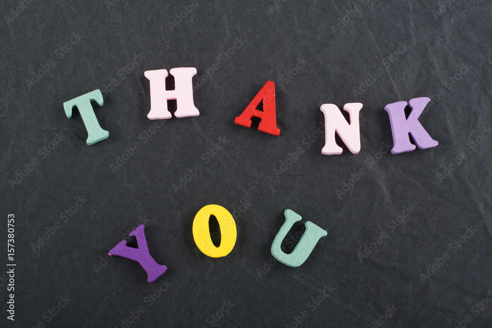 THANK YOU word on black board background composed from colorful abc alphabet block wooden letters, copy space for ad text. Learning english concept. THANK YOU word on black board background composed from colorful abc alphabet block wooden letters, copy space for ad text. Learning english concept.