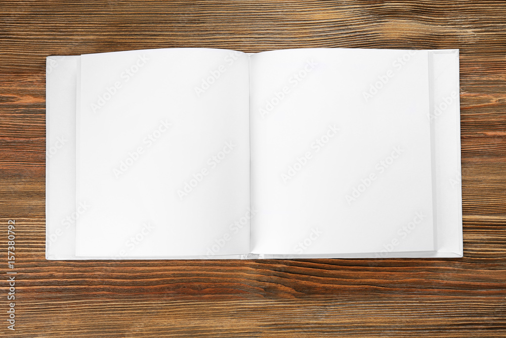 Blank pages of opened book on wooden background Blank pages of opened book on wooden background