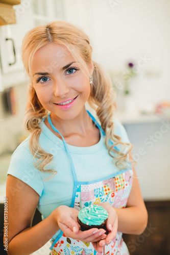 Smiling young housewife. Cooking baking in the kitchen