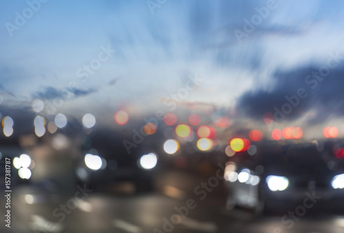 Traffic in city, lights of cars in the evening