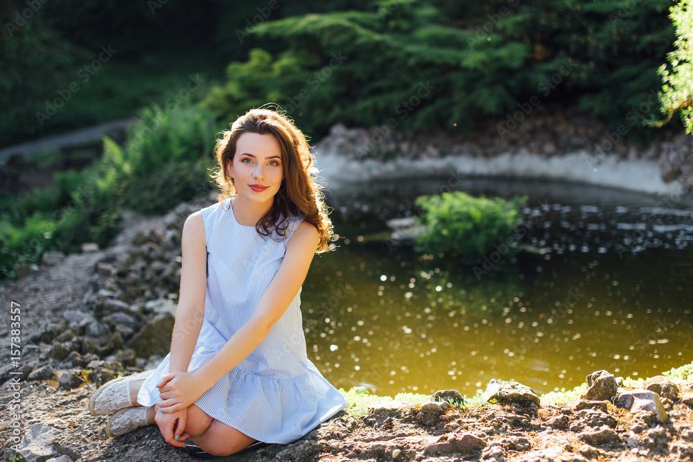 Pretty girl pose to camera at park with sunlight background Pretty girl pose to camera at park with sunlight background