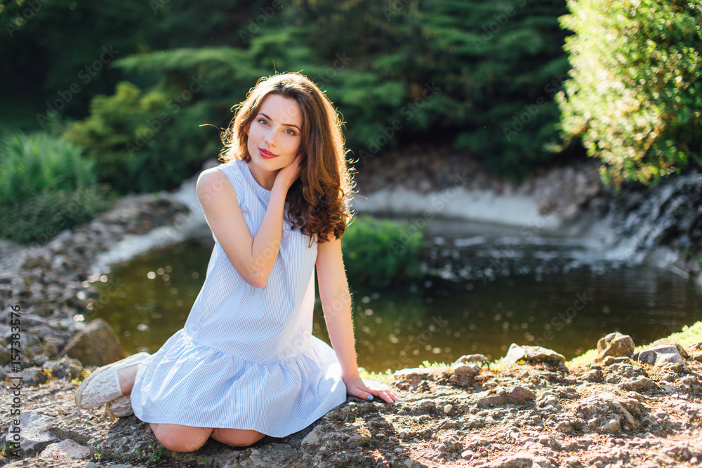 Pretty girl pose to camera at park with sunlight background Pretty girl pose to camera at park with sunlight background