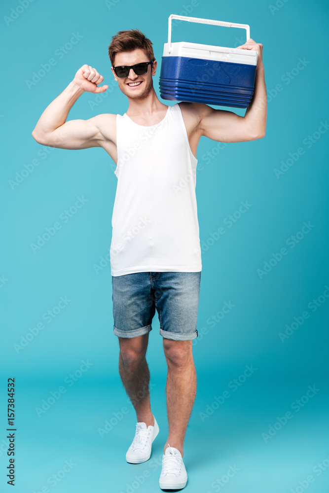 Happy man standing over blue isolated background. Happy man standing over blue isolated background.
