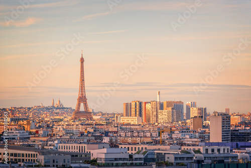 Aerial scenic view of Paris with the Eiffel tower at sunset, Montmartre in the background, France and Europe city travel concept © Delphotostock
