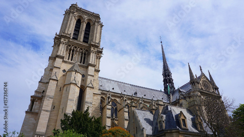 Photo of famous Notre Dame cathedral on a cloudy spring morning, Paris, France