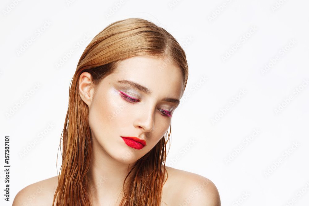 Obraz premium Close-up portrait of young beautiful girl with bright make up. White background. Isolated.