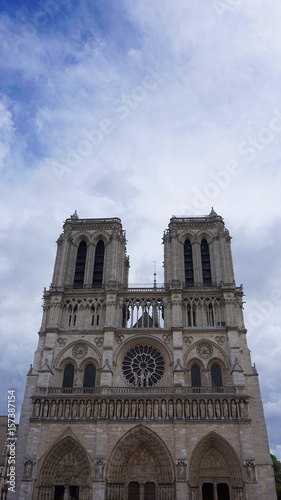 Photo of famous Notre Dame cathedral on a cloudy spring morning, Paris, France
