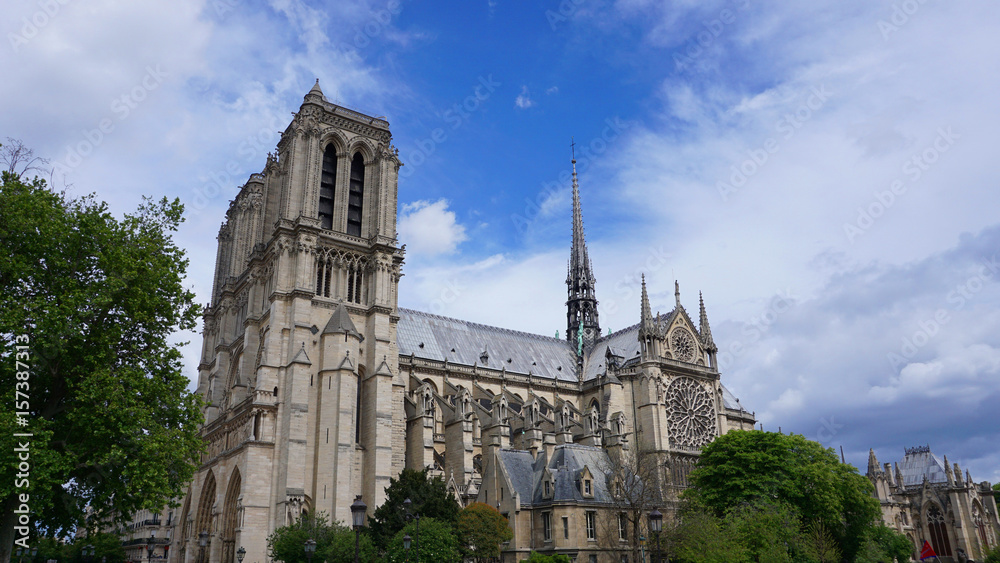 Photo of famous Notre Dame cathedral on a cloudy spring morning, Paris, France