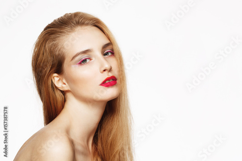 Close-up portrait of young beautiful confident girl with bright make up. White background. Isolated.