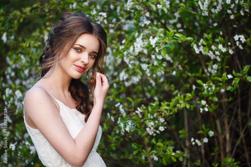 Happy smiling young woman with spring flowers at garden Happy smiling young woman with spring flowers at garden