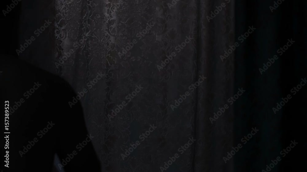 Beautiful, young man unveil curtain. Slow motion Beautiful, young man unveil curtain. Slow motion