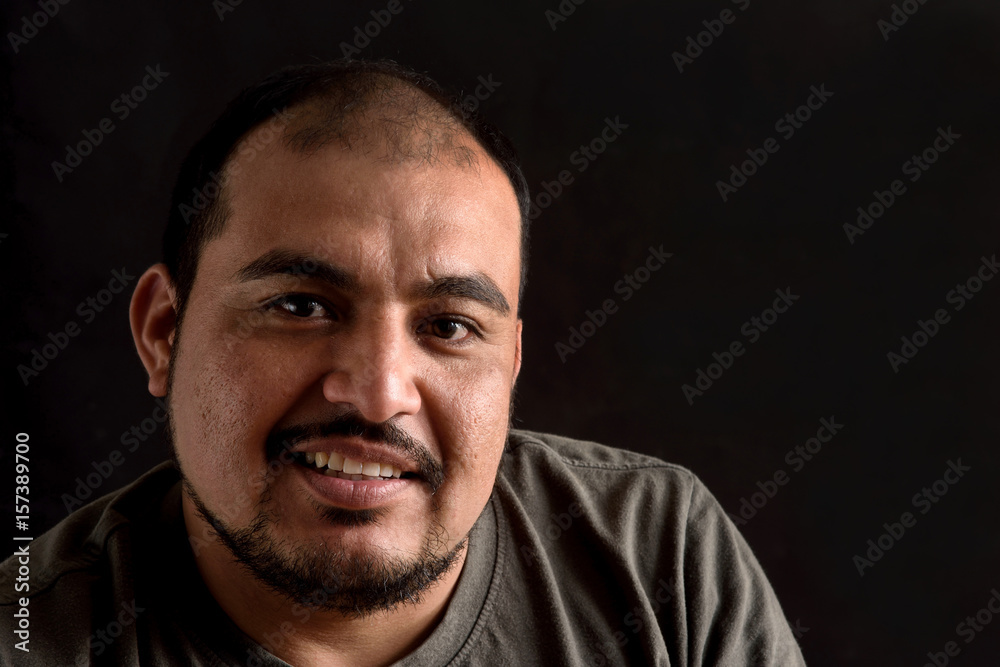 Portrait of a latin man on black background