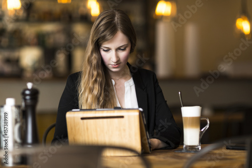 young business woman working at cafe at break