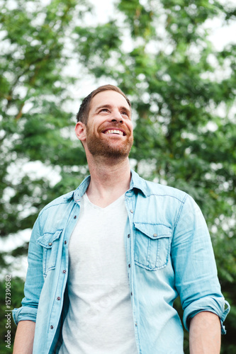 Casual guy with a denim shirt in a park