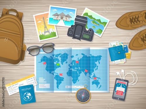 Preparing for vacation, travel, journey. Travel planning. Booking hotel. Wooden table with shoes, world map, photos, air ticket, passport, luggage, wallet, camera, compass, headphones. Vector top view