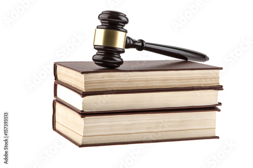 Old books and a wooden hammer isolated on a white background