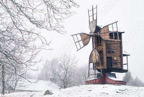 Winter landscape with old and abandoned windmill at daytime in Finland