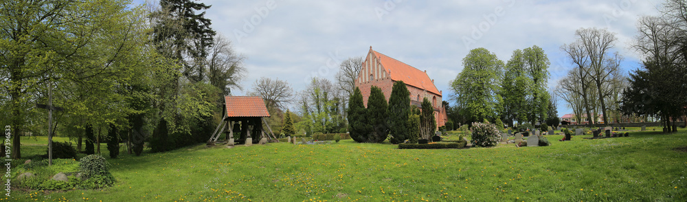 Fototapeta premium Church and cemetery of Behrenhoff with a wooden cross