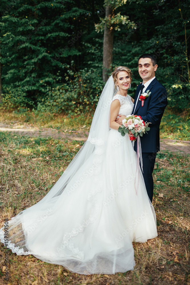 Stunning wedding couple poses in the forest