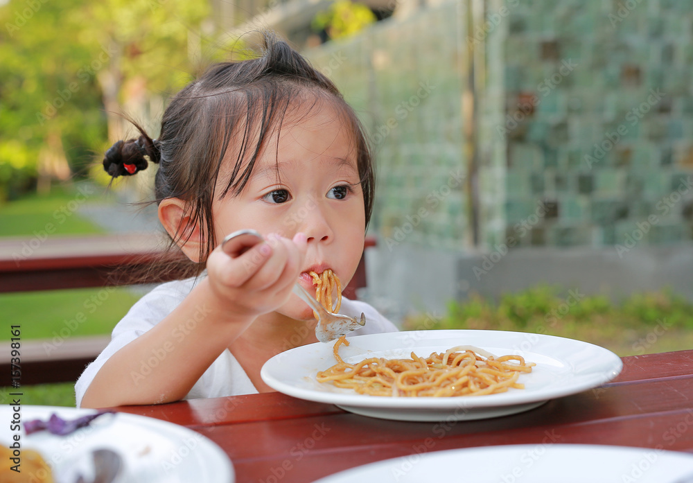 Kid girl eating Japanese yakisoba noodles. Kid girl eating Japanese yakisoba noodles.