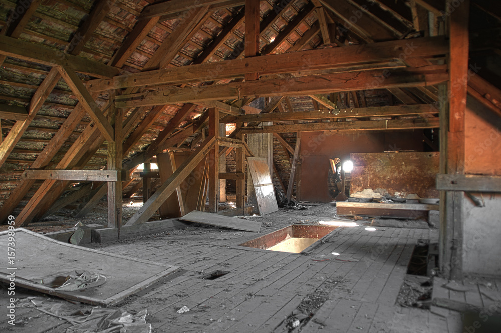 Old damaged attic with wooden beams