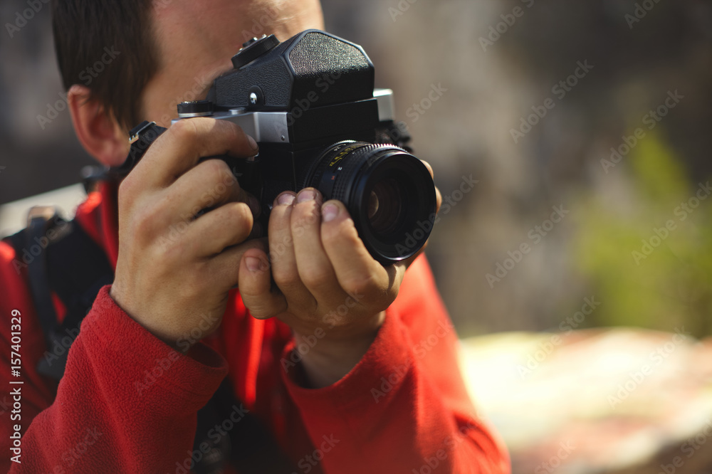 Old camera in the hands of the photographer.